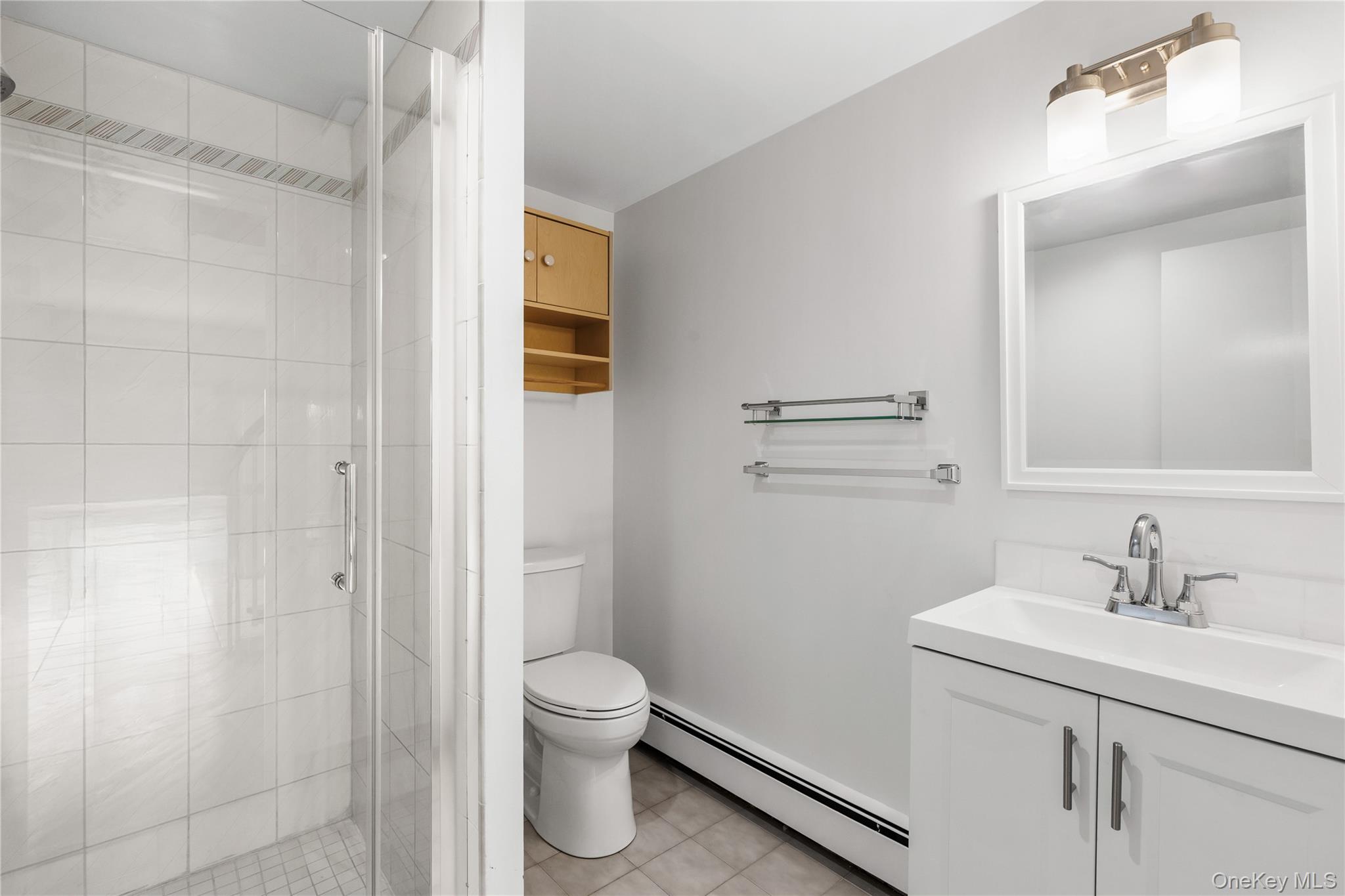 3 Lakeside Drive Rye, NY 10580 - Photo 13 of 31 a bathroom with a sink a toilet and shower