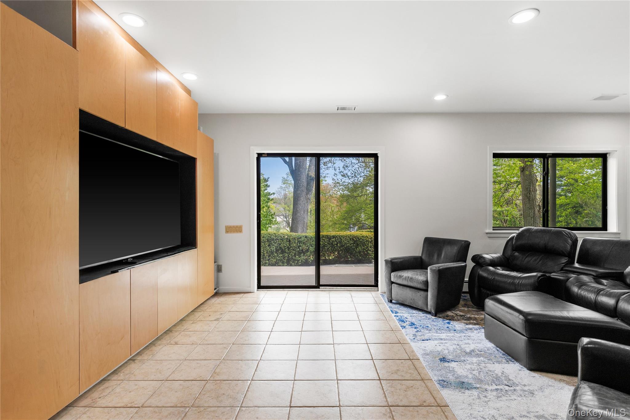 3 Lakeside Drive Rye, NY 10580 - Photo 16 of 31 a living room with furniture tv and a flat screen tv
