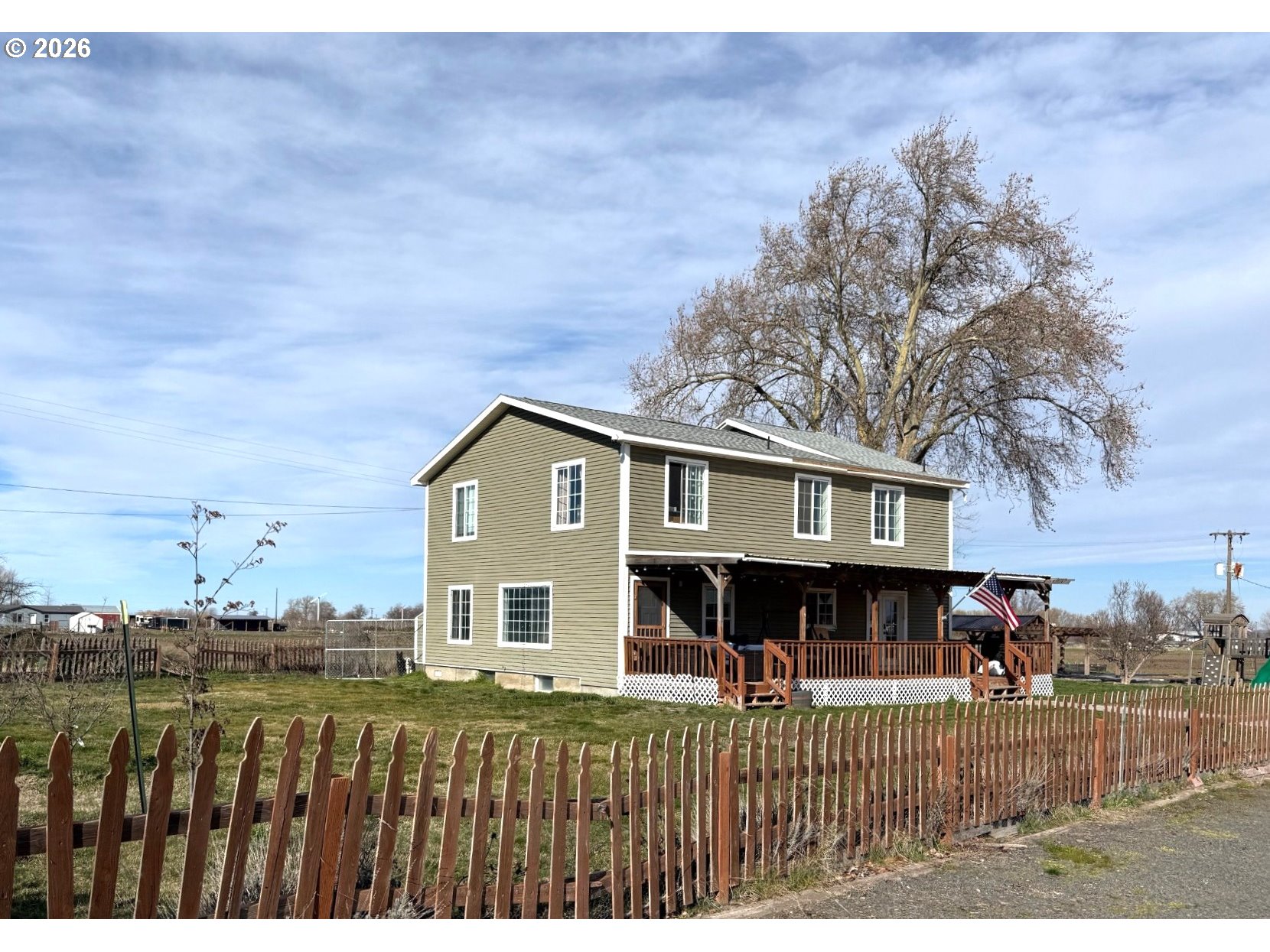 a view of a house with a wooden deck