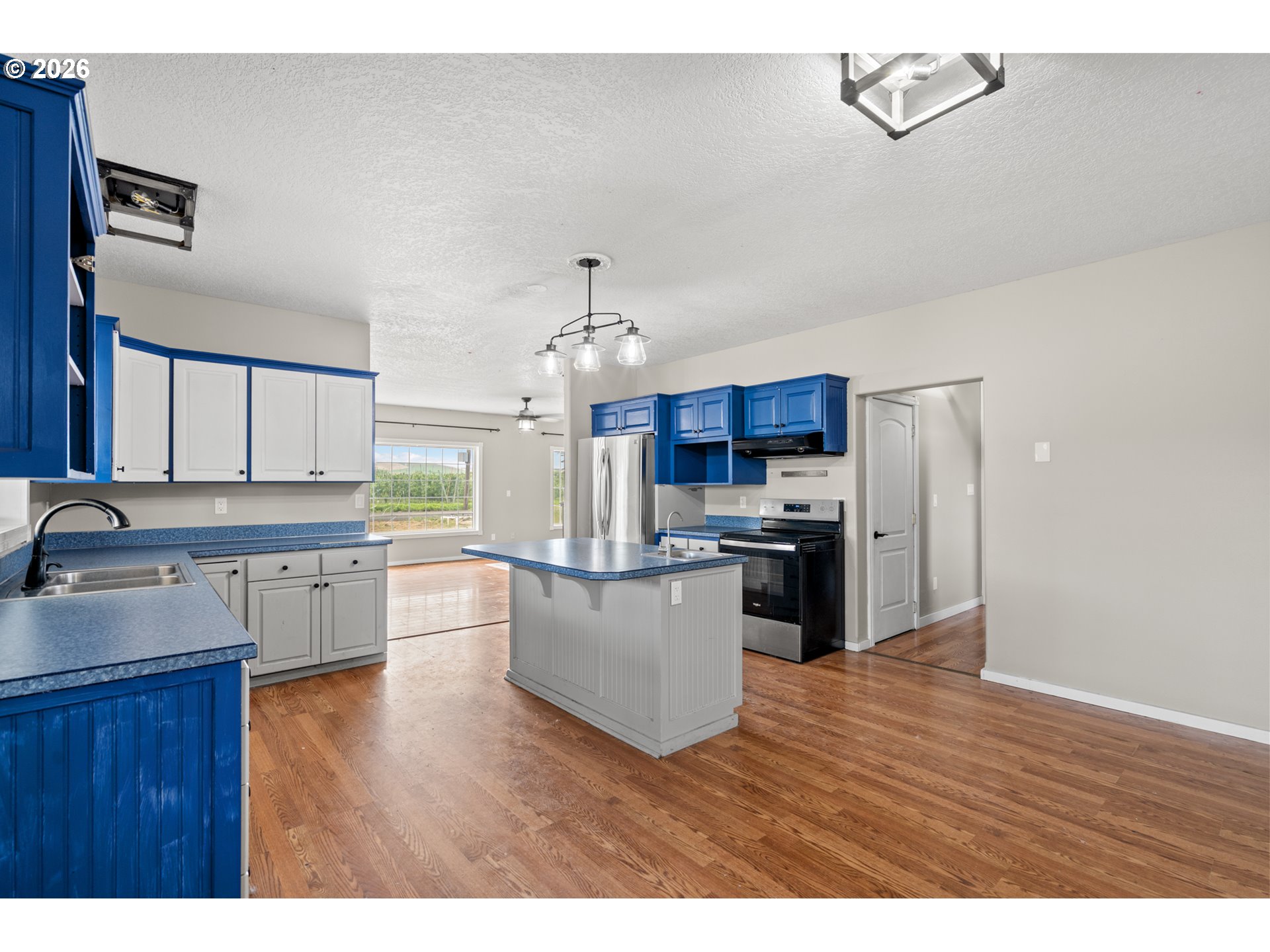 53671 Appleton Road Milton Freewater, OR 97862 - Photo 21 of 41 a kitchen with stainless steel appliances kitchen island granite countertop a refrigerator a sink dishwasher a stove with wooden floor