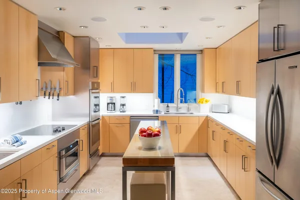 a kitchen with a sink and a refrigerator