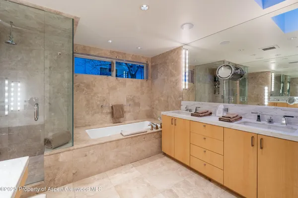 a large white kitchen with a stove a sink and a refrigerator