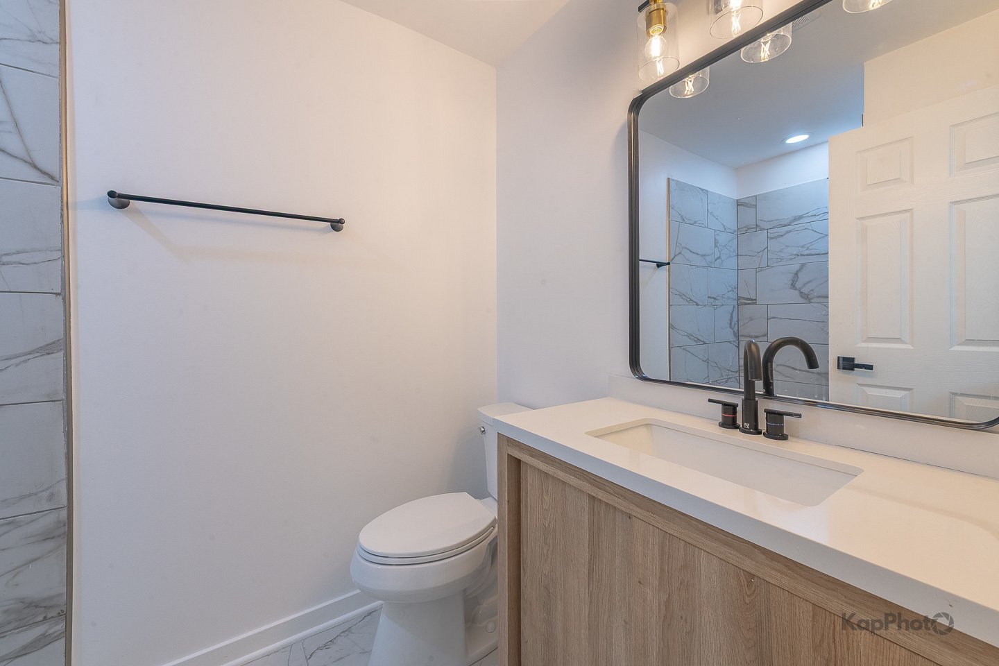 2139 West 24th Street Chicago, IL 60608 - Photo 23 of 29 a bathroom with a sink a toilet a mirror and vanity