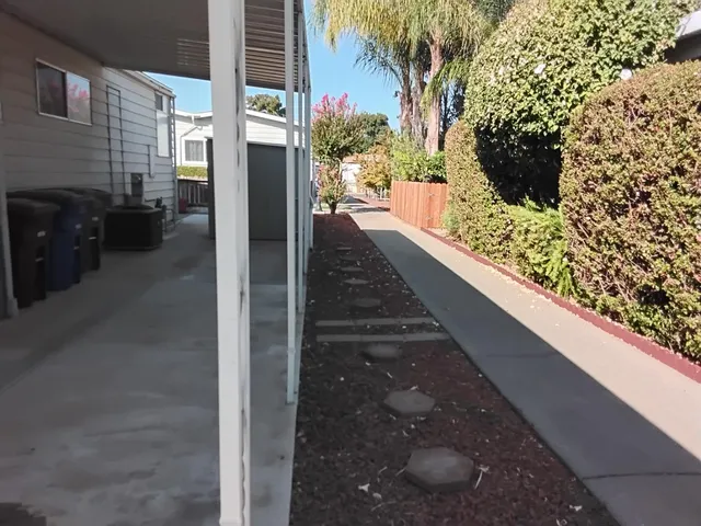 a kitchen with granite countertop a refrigerator and a stove top oven
