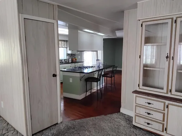 a front view of a house with a garden and plants