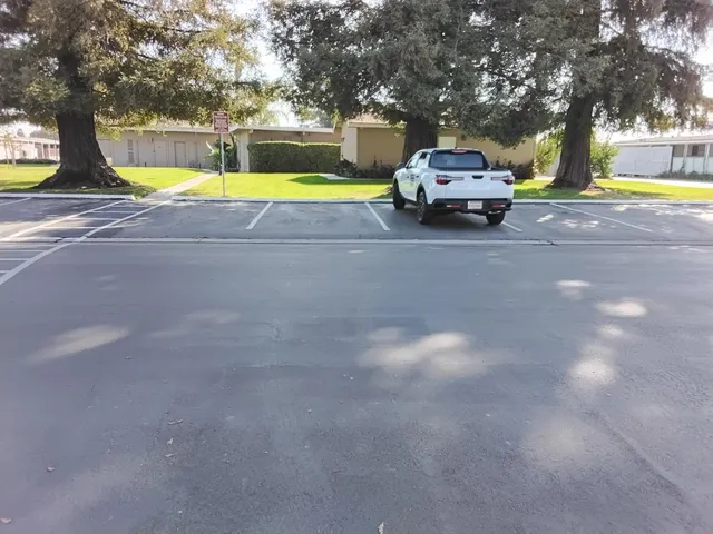 a view of a swimming pool with lawn chairs and a big yard