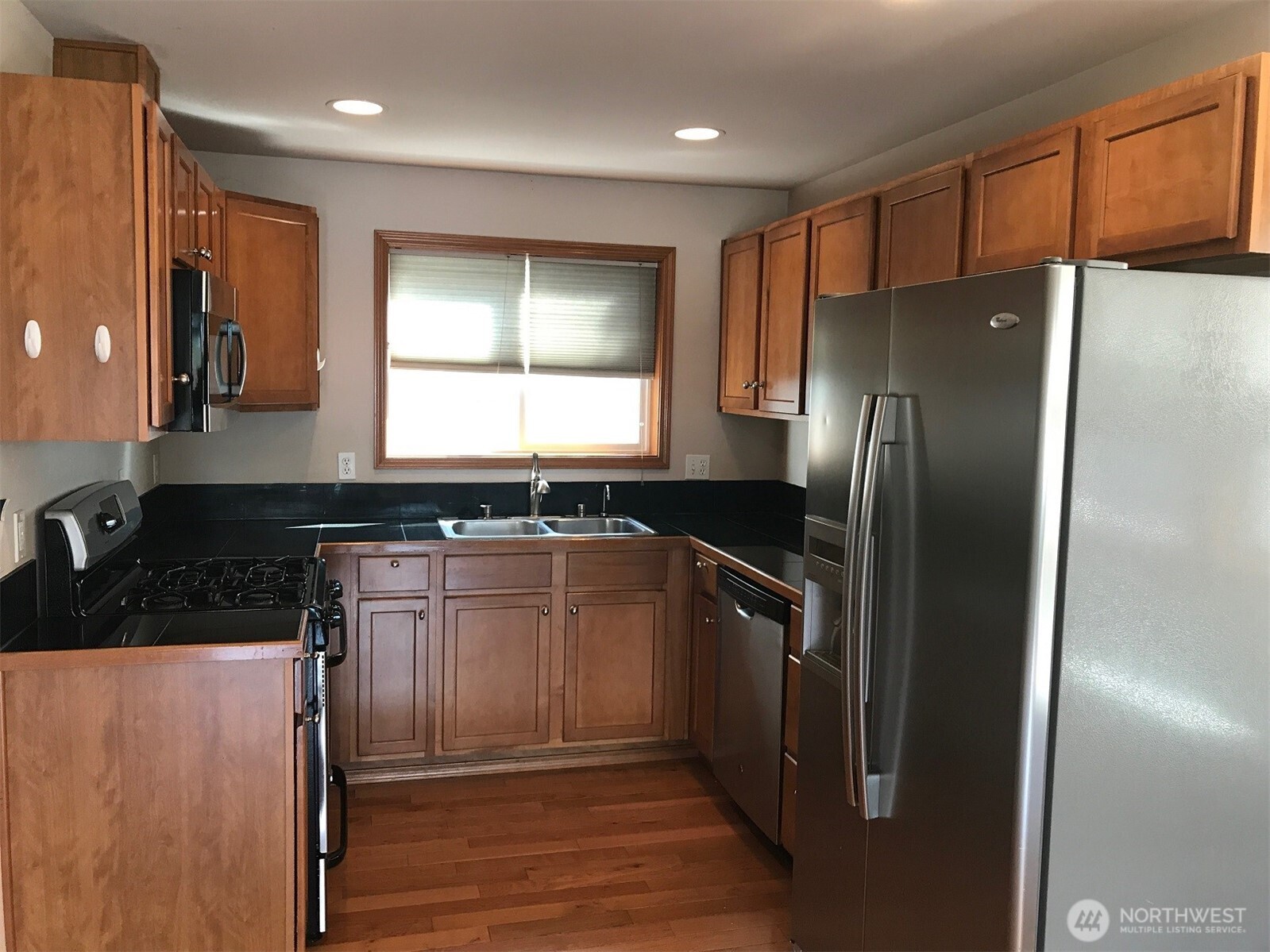 12723 35th Avenue Northeast, Unit A Seattle, WA 98125 - Photo 3 of 11 a kitchen with granite countertop a refrigerator and a sink