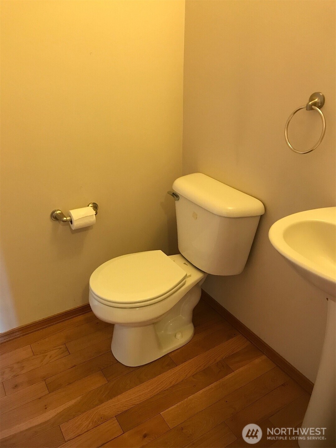 12723 35th Avenue Northeast, Unit A Seattle, WA 98125 - Photo 4 of 11 a white toilet sitting next to a bathroom sink