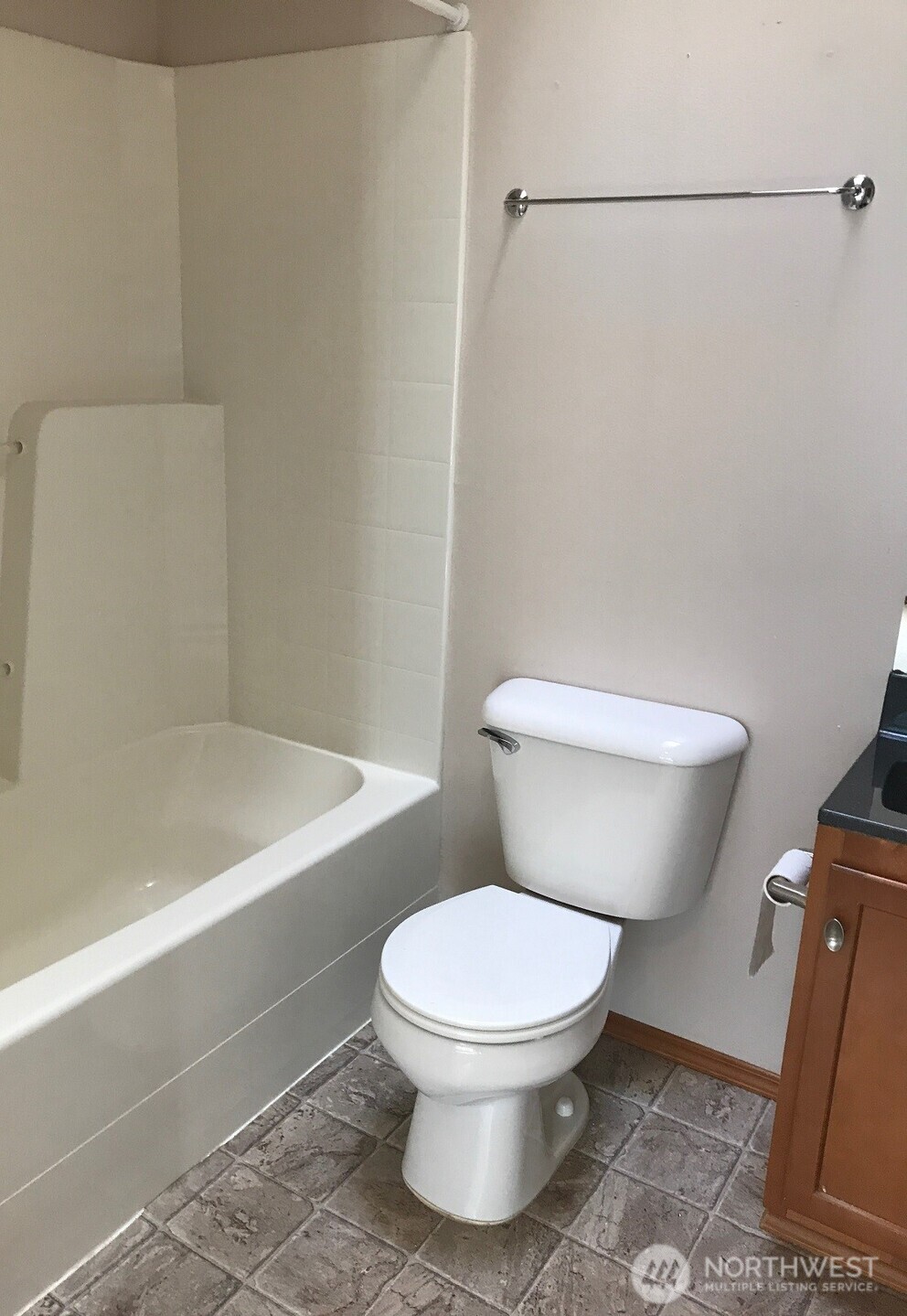 12723 35th Avenue Northeast, Unit A Seattle, WA 98125 - Photo 9 of 11 a white toilet sitting next to a bath tub and a shower