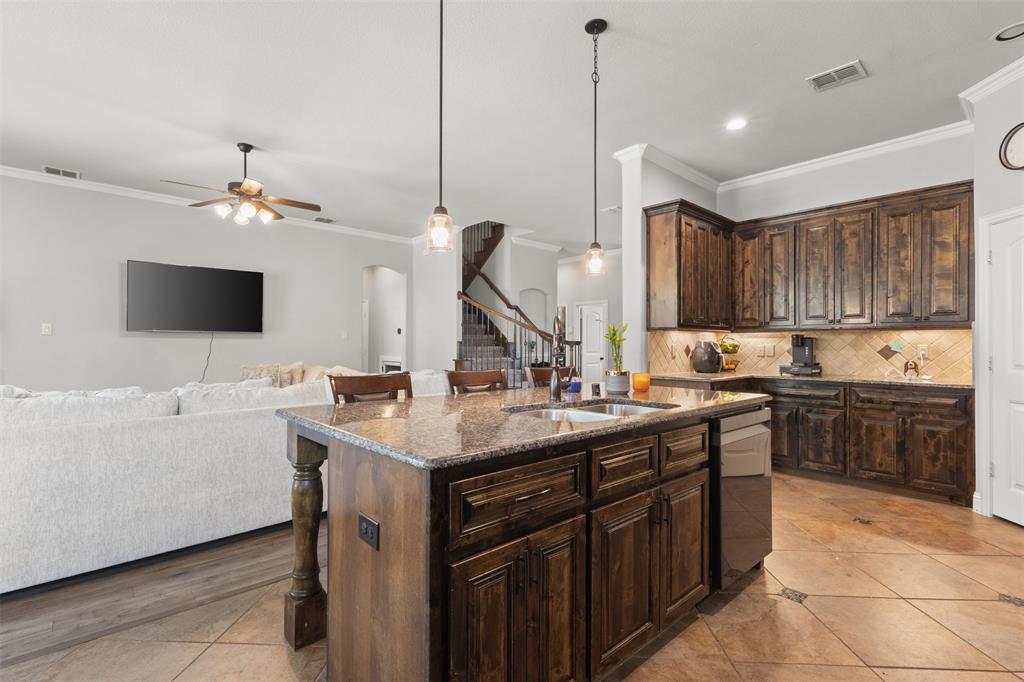 800 Goose Court Forney, TX 75126 - Photo 15 of 34 a kitchen with a sink a counter top space appliances and cabinets