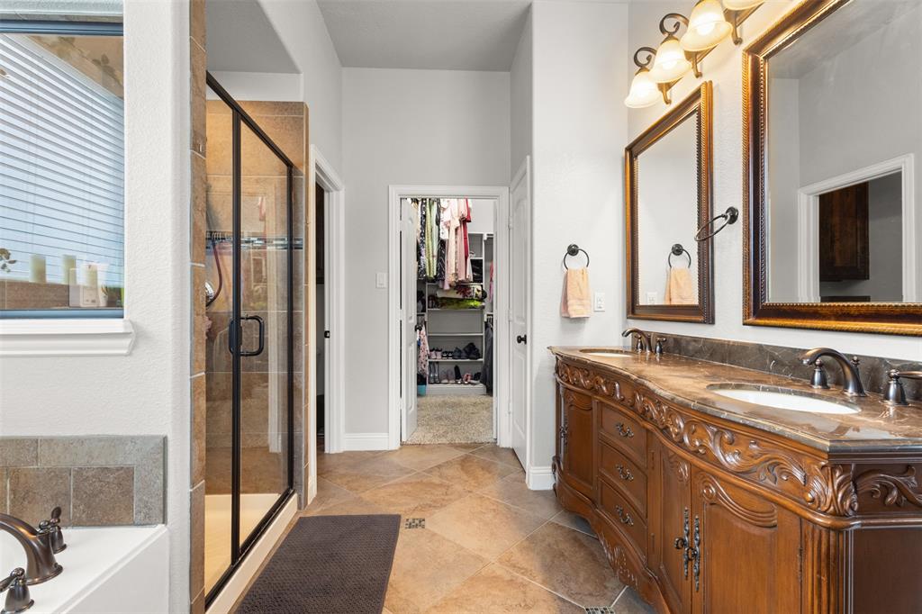 800 Goose Court Forney, TX 75126 - Photo 25 of 34 a bathroom with a granite countertop sink and a mirror