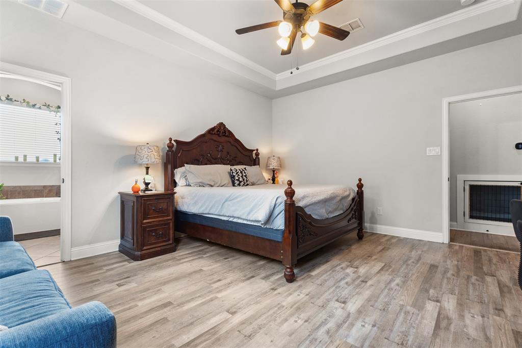 800 Goose Court Forney, TX 75126 - Photo 27 of 34 a bedroom with a bed and a fireplace