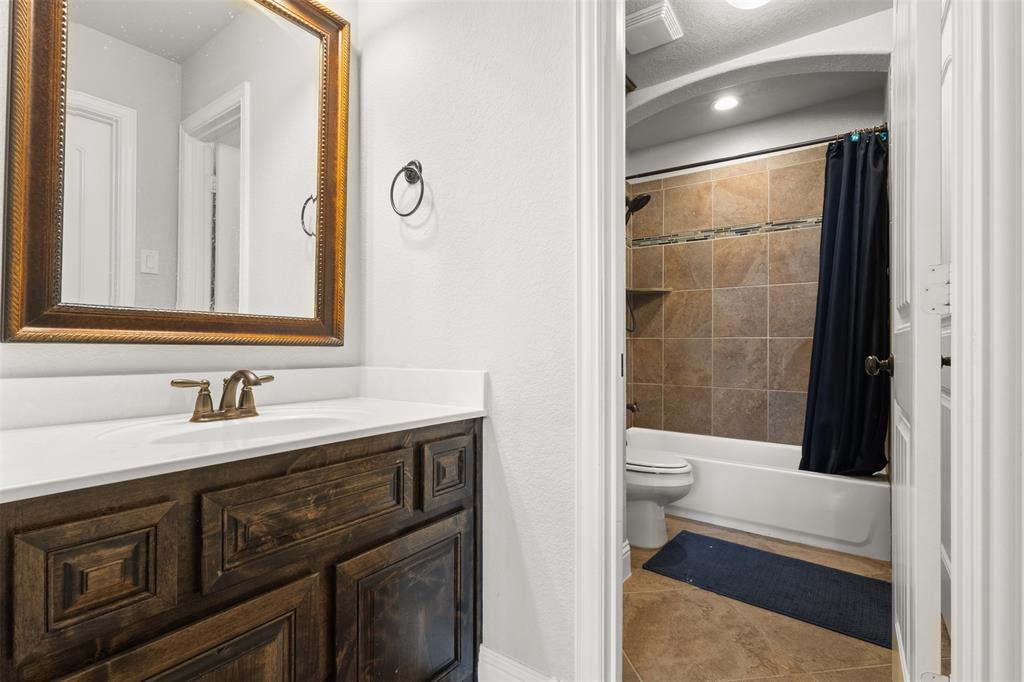 800 Goose Court Forney, TX 75126 - Photo 29 of 34 a bathroom with a sink a toilet and shower