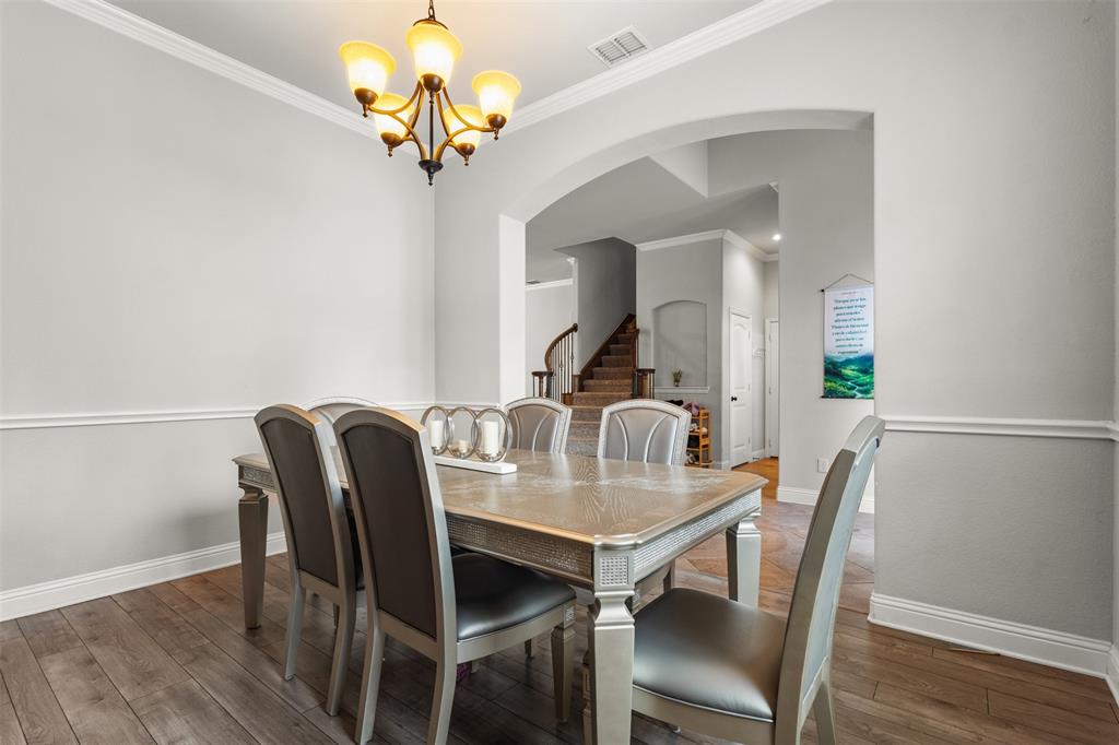 800 Goose Court Forney, TX 75126 - Photo 7 of 34 a view of a dining room with furniture and wooden floor