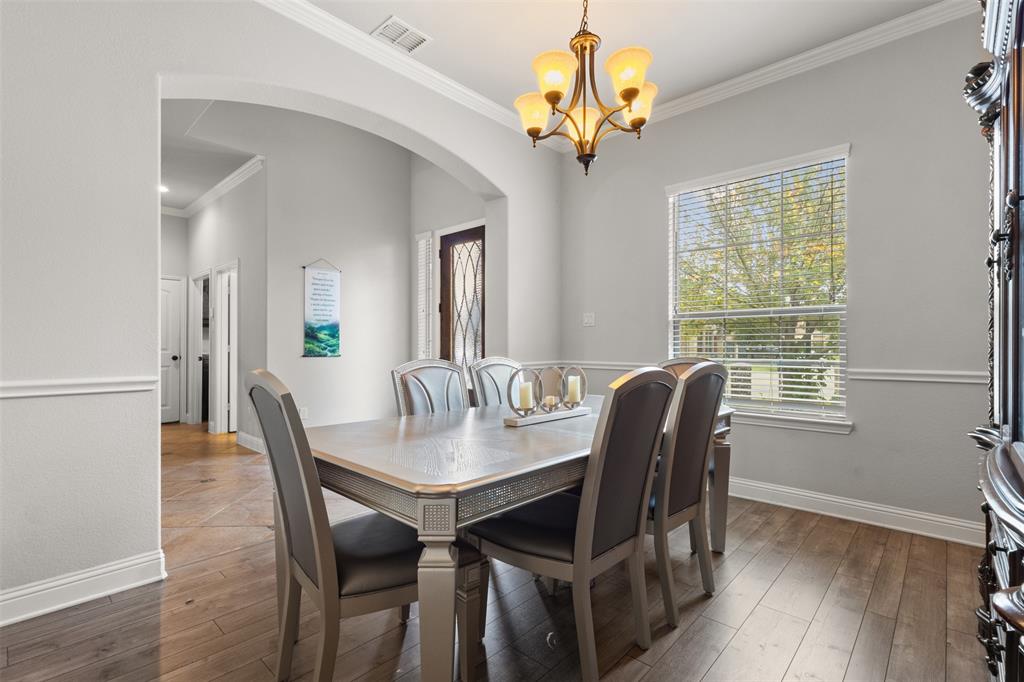 800 Goose Court Forney, TX 75126 - Photo 8 of 34 a view of a dining room with furniture window and wooden floor