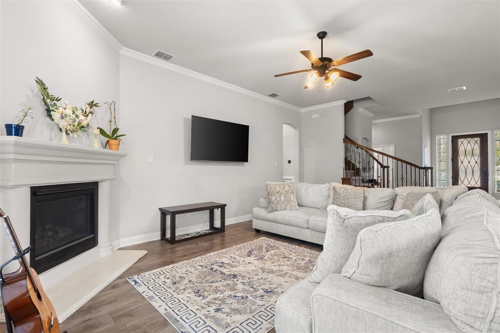 800 Goose Court Forney, TX 75126 - Photo 9 of 34 a living room with furniture and a fireplace