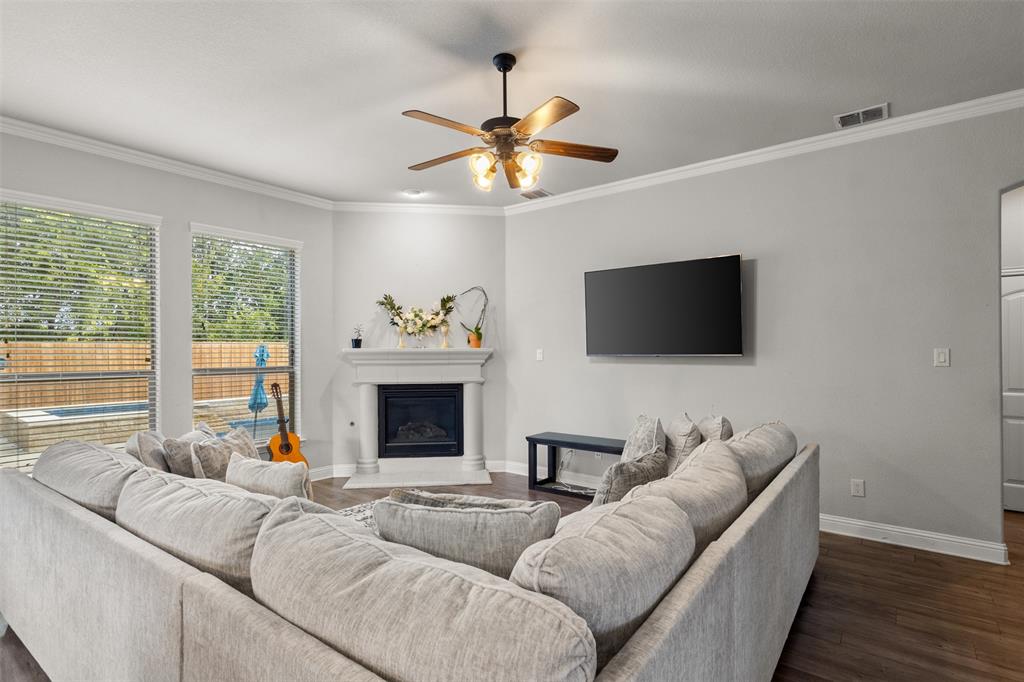 800 Goose Court Forney, TX 75126 - Photo 10 of 34 a living room with furniture a fireplace and a flat screen tv