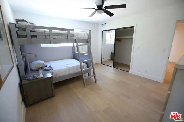 a bedroom with a bed and cabinets