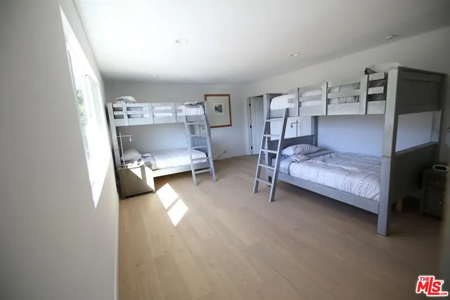 a bedroom with bed and window