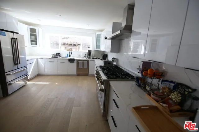 a kitchen with a sink appliances and cabinets