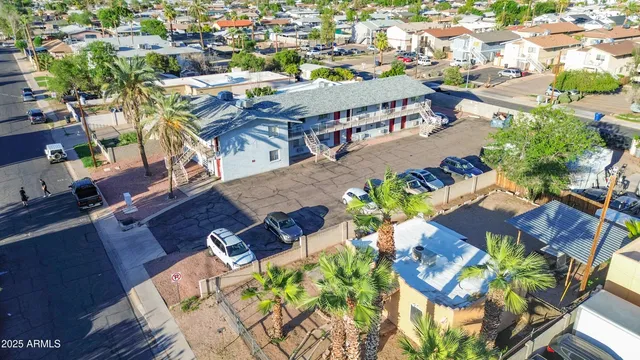 an aerial view of a swimming pool with outdoor seating