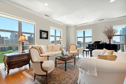 a bedroom with furniture and a large window