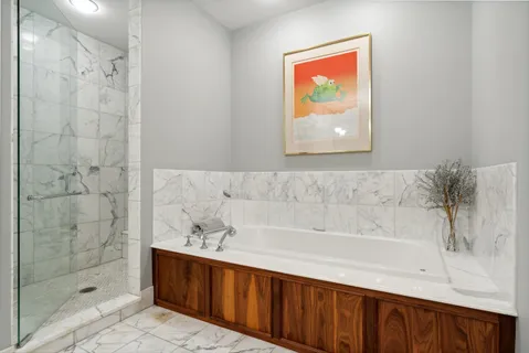 a bathroom with a bathtub and shower