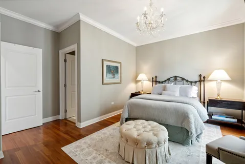 a bedroom with bed and wooden floor