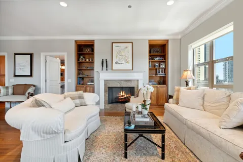a living room with furniture fireplace and window