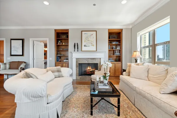 a living room with furniture fireplace and window