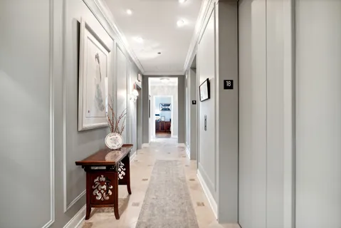 a very nice looking hallway with a chair