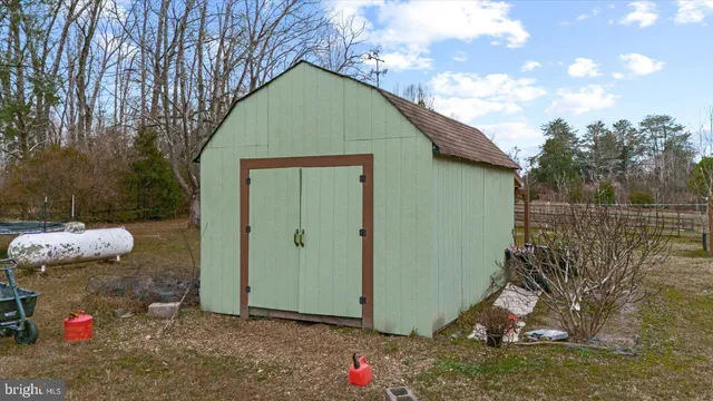 a white house that has a tree in front of it