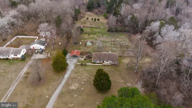 a view of empty room with wooden floor and fireplace