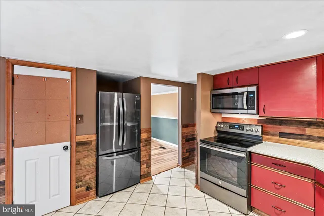 a kitchen with stainless steel appliances a refrigerator and a stove top oven