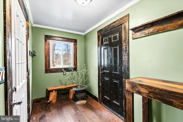 a view of a livingroom with furniture and hardwood floor