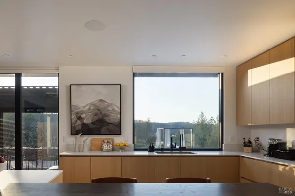 a living room with a large window and a wooden floor