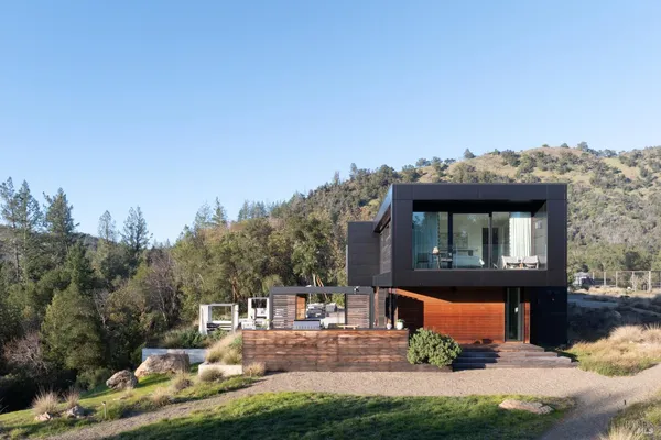 a view of a house with a yard balcony and sitting area