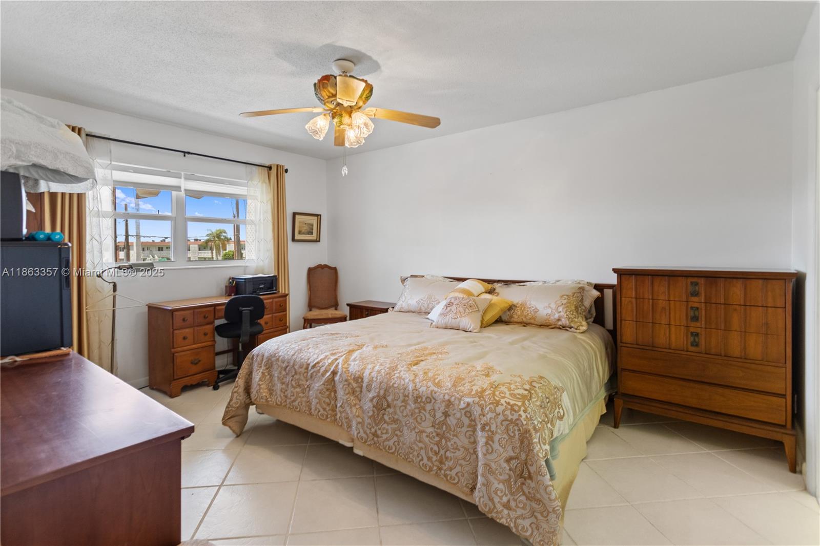 4299 Northwest 16th Street, Unit 210 Lauderhill, FL 33313 - Photo 15 of 37 a bedroom with a bed and a table