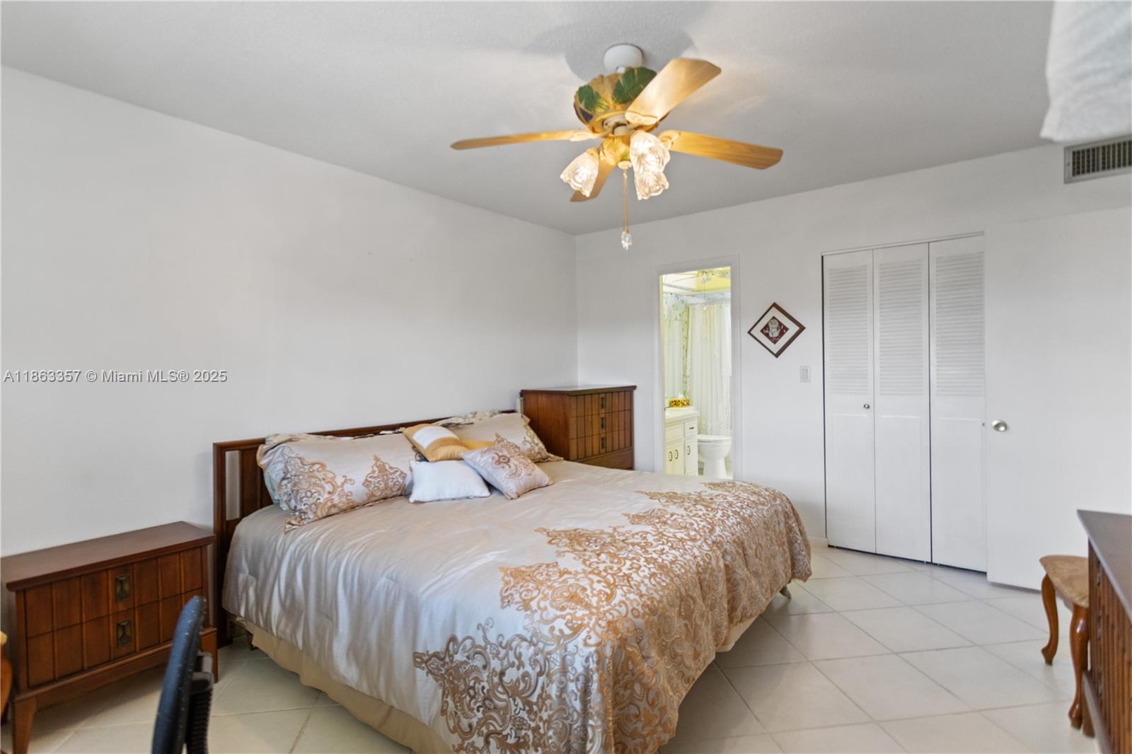 4299 Northwest 16th Street, Unit 210 Lauderhill, FL 33313 - Photo 17 of 37 a bedroom with a bed and a chandelier