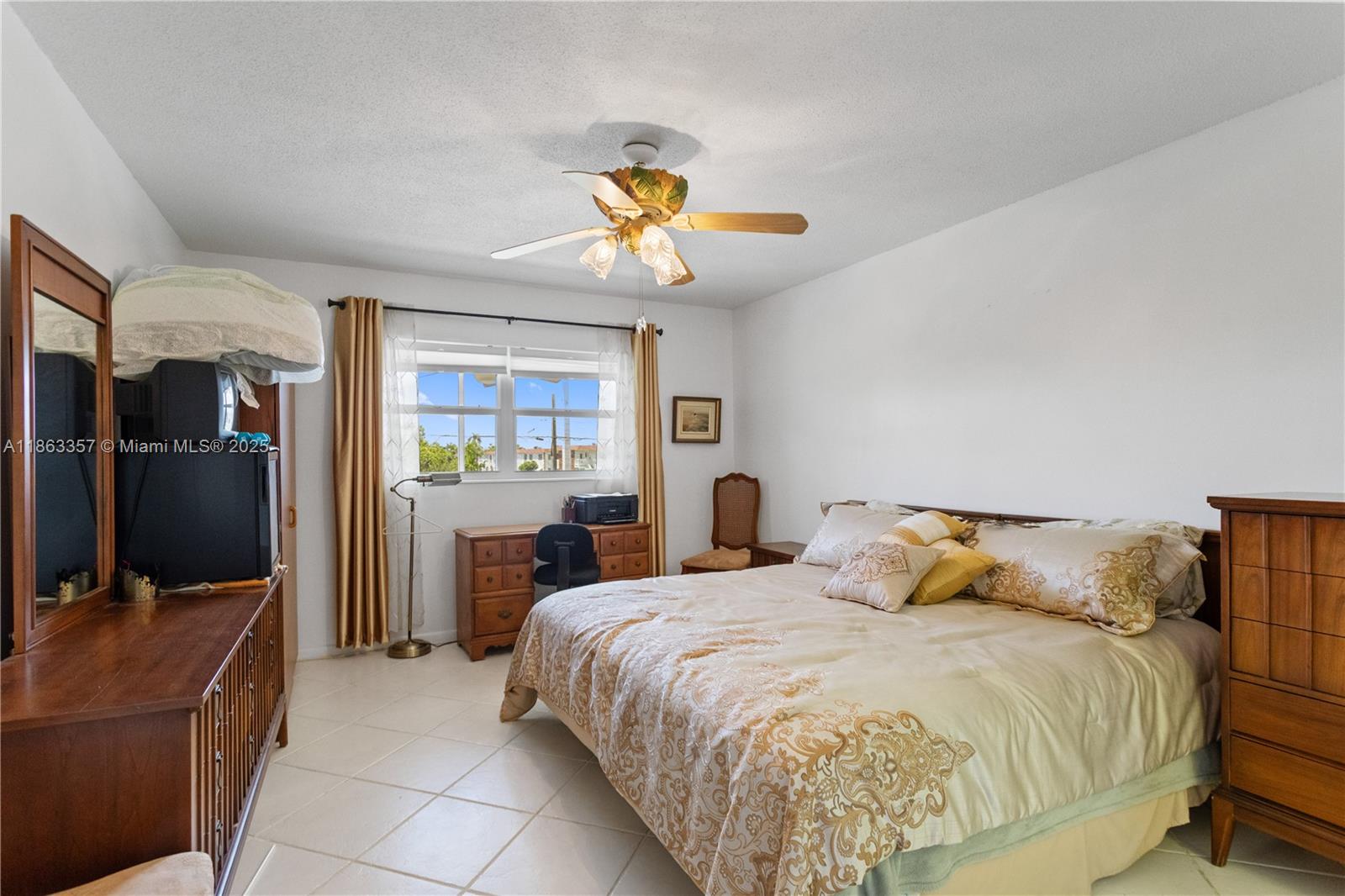 4299 Northwest 16th Street, Unit 210 Lauderhill, FL 33313 - Photo 18 of 37 a bedroom with a bed and a flat screen tv