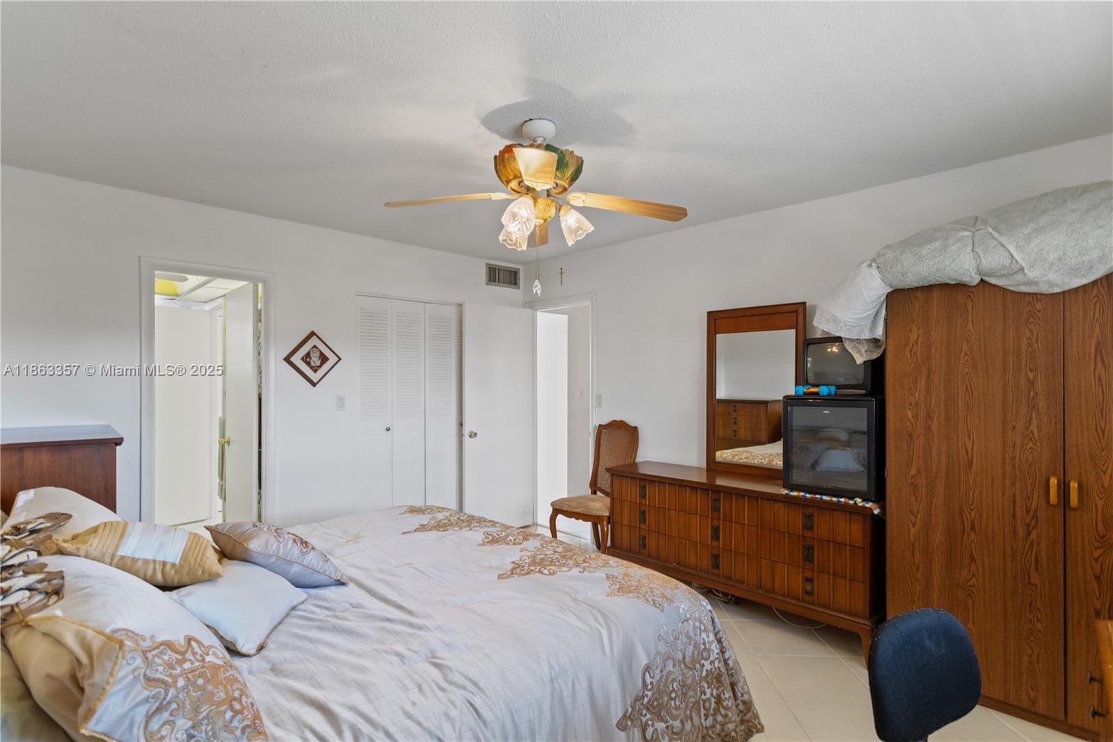 4299 Northwest 16th Street, Unit 210 Lauderhill, FL 33313 - Photo 19 of 37 a bedroom with a bed and a chandelier