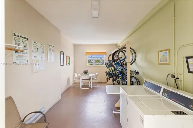 a view of a hallway with wooden floor and a bathroom