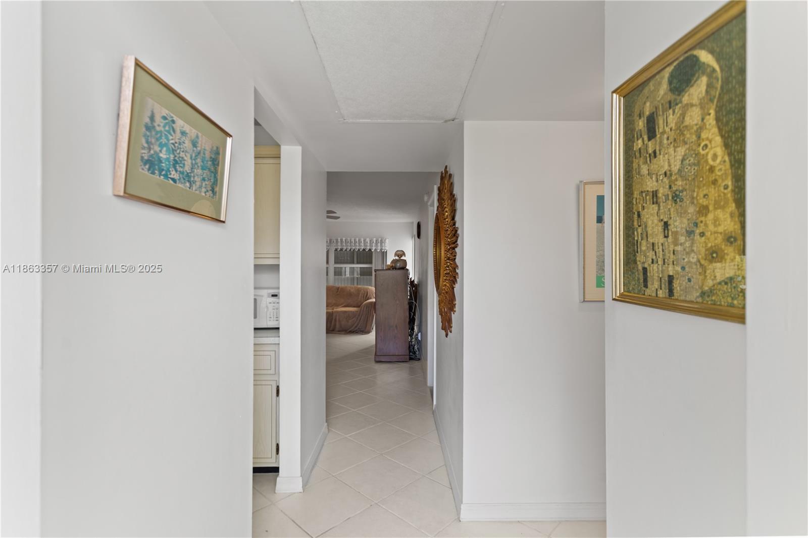 4299 Northwest 16th Street, Unit 210 Lauderhill, FL 33313 - Photo 23 of 37 a view of a hallway with wooden floor and a bathroom