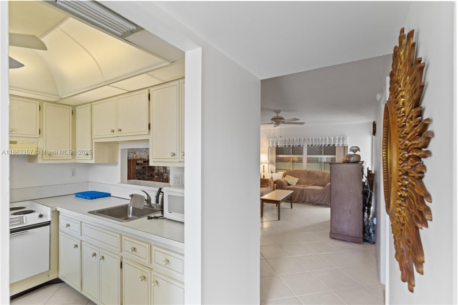4299 Northwest 16th Street, Unit 210 Lauderhill, FL 33313 - Photo 24 of 37 a kitchen that has a lot of cabinets a sink and a stove