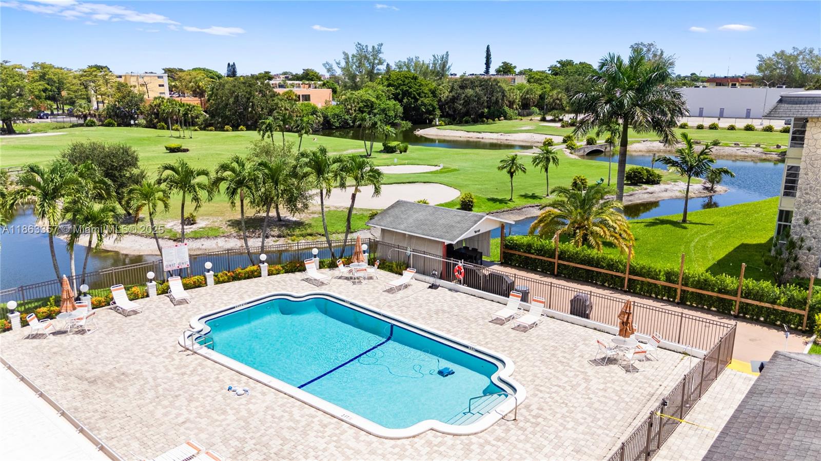 4299 Northwest 16th Street, Unit 210 Lauderhill, FL 33313 - Photo 28 of 37 a view of a swimming pool with a patio and a yard