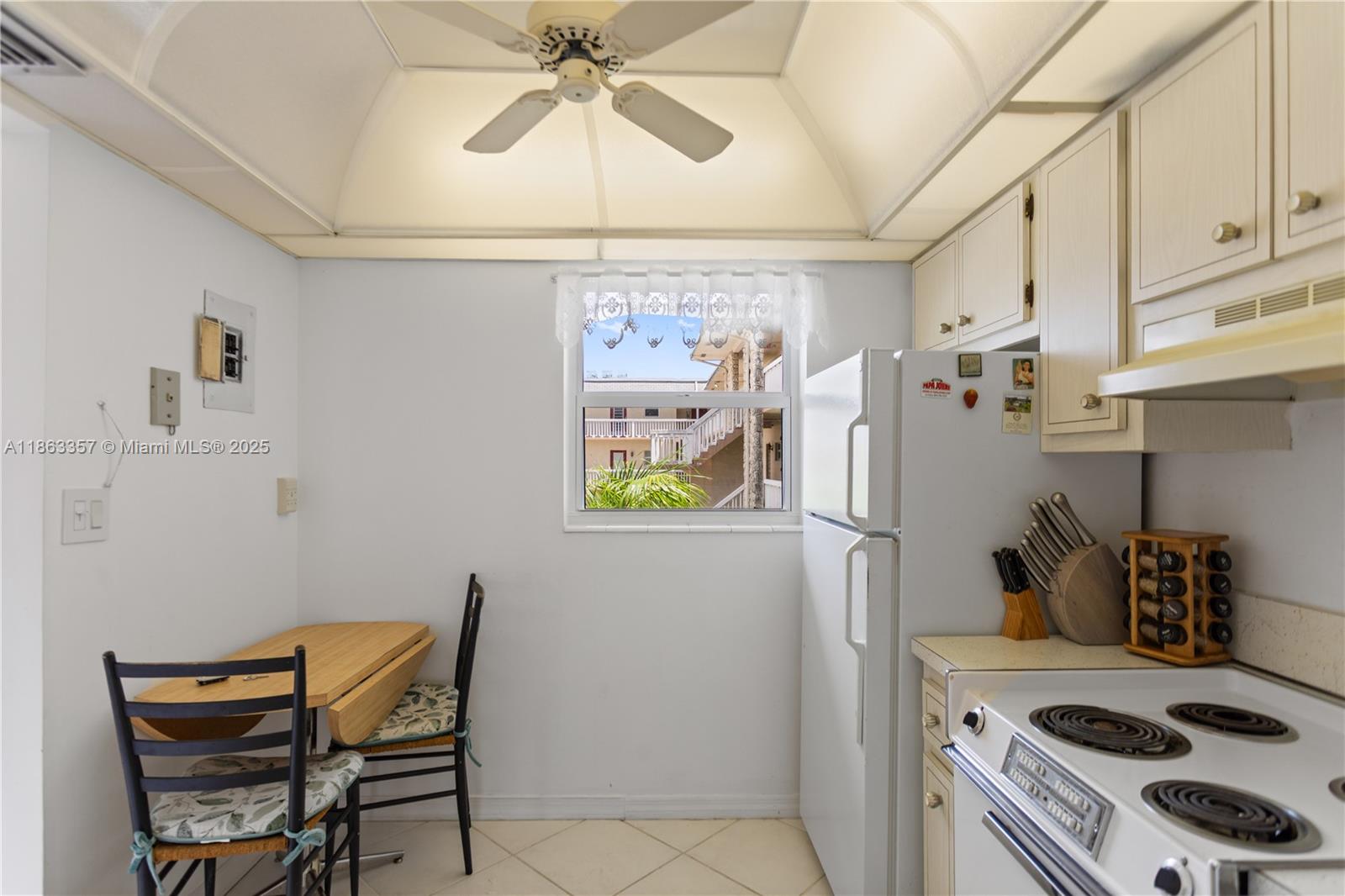 4299 Northwest 16th Street, Unit 210 Lauderhill, FL 33313 - Photo 3 of 37 a kitchen with stainless steel appliances a stove a refrigerator cabinets and a dining table
