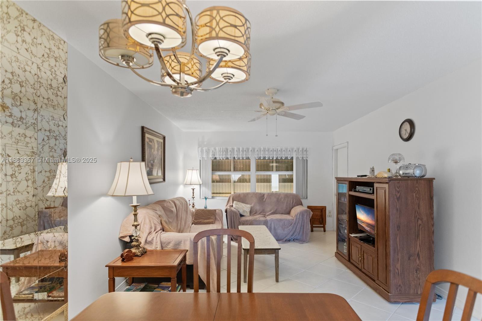 4299 Northwest 16th Street, Unit 210 Lauderhill, FL 33313 - Photo 6 of 37 a living room with furniture a fireplace and a large window