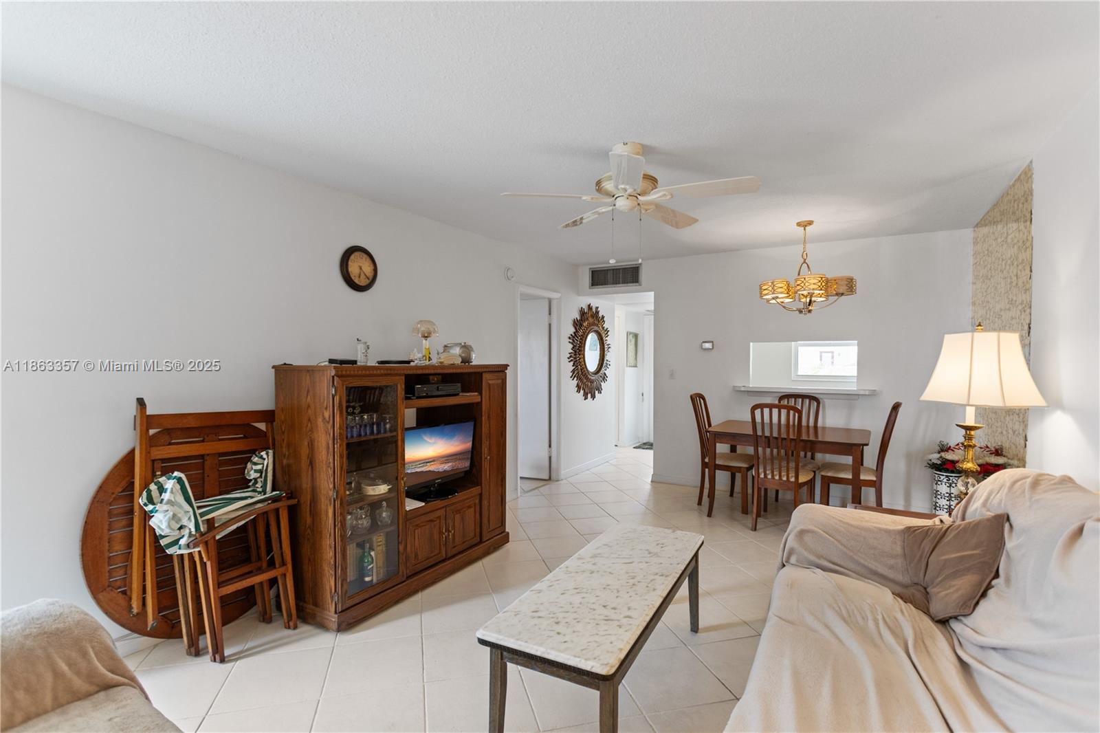 4299 Northwest 16th Street, Unit 210 Lauderhill, FL 33313 - Photo 8 of 37 a living room with furniture and a flat screen tv