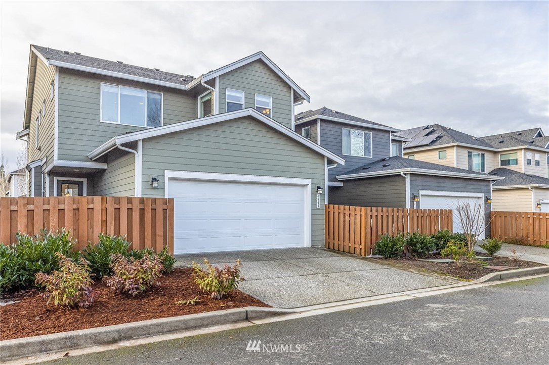 4303 Riverfront Boulevard Everett, WA 98203 - Photo 2 of 40 a front view of a house with a yard and garage