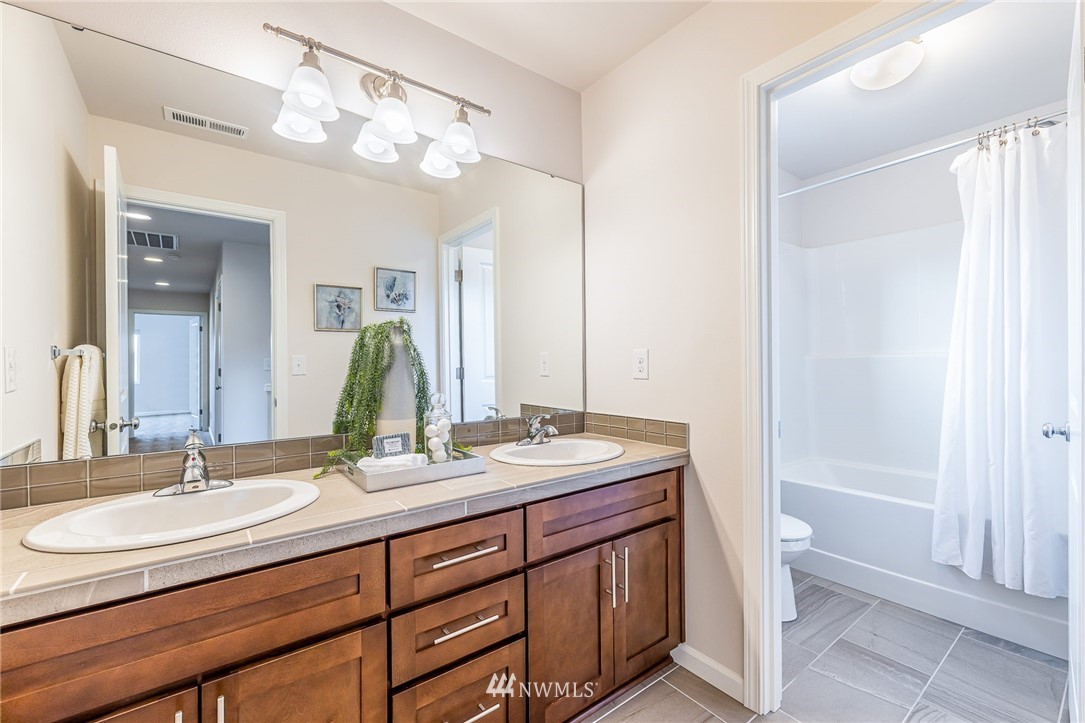 4303 Riverfront Boulevard Everett, WA 98203 - Photo 21 of 40 a bathroom with a double vanity sink and a mirror